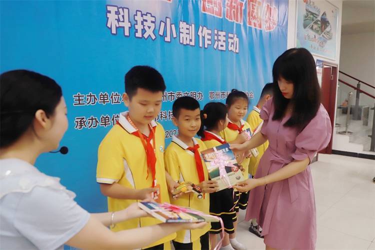 2021年7月9日鄂州市科協(xié)組織新民街小學(xué)學(xué)生在鄂州市科技館開展社會主義核心價(jià)值觀系列活動，圖為開展的科技創(chuàng)新圓夢中華科技小制作活動，科協(xié)王雨濛部長正在為優(yōu)先制作完成的學(xué)生頒發(fā)獎(jiǎng)品.jpg